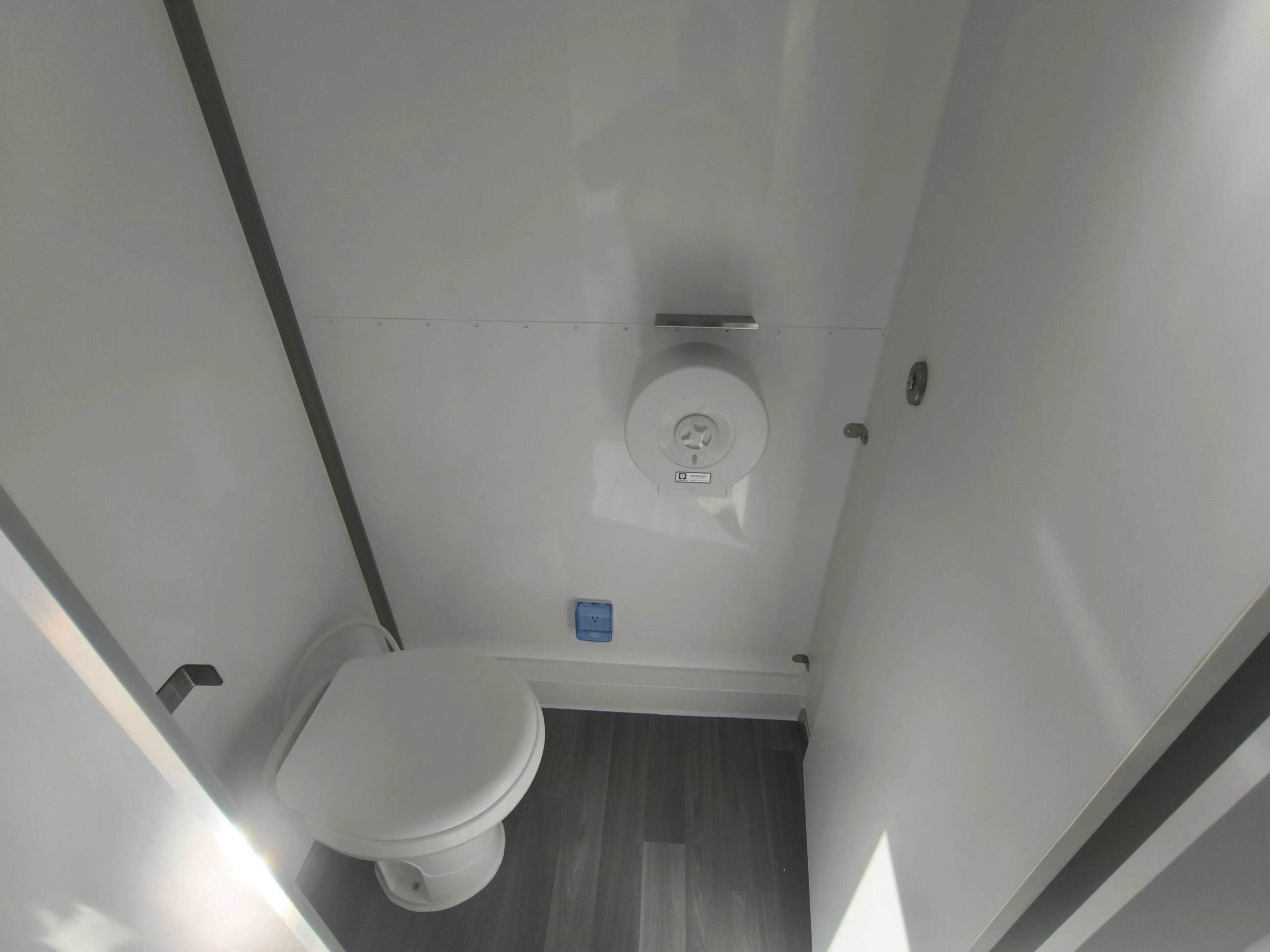 Custom restroom trailer WC interior with modern fixtures and compact design by Luxe Custom Co, expert trailer builders.