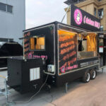 Rear exterior of a BBQ concession trailer for sale, showcasing access panels by Luxe Custom Co.