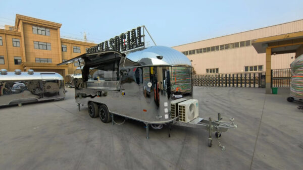 Silver round-body bar trailer with open window and AC unit, built by Luxe Custom Co.