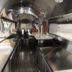 Opposite side of bar trailer interior with counter space and storage, crafted by Luxe Custom Co.