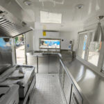 Compact interior of a custom food trailer with stainless steel setup, designed for buy food trailer needs by Luxe Custom Co.