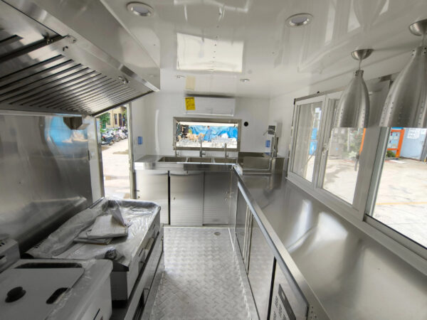 Compact interior of a custom food trailer with stainless steel setup, designed for buy food trailer needs by Luxe Custom Co.