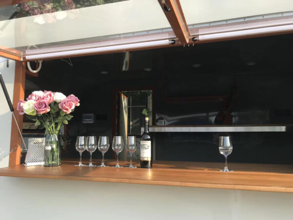 Interior of a custom concession trailer for crafted bars with stainless steel counters, built by Luxe Custom Co.