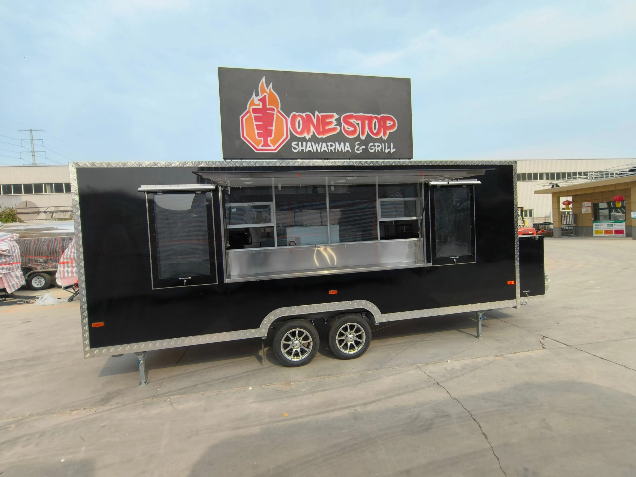 Left-side exterior of an 18ft square-body concession trailer for sale, built by Luxe Custom Co food trailer builders.