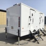 Custom bathroom trailer exterior with vibrant wrap and durable design by Luxe Custom Co, expert custom trailer builders.