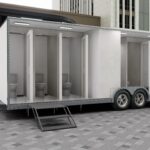 Modern bathroom trailer interior with high-end fixtures and smart storage by Luxe Custom Co, custom trailer experts.