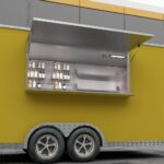 Yellow exterior of a mobile food trailer with open serving window for bar service, built by Luxe Custom Co.