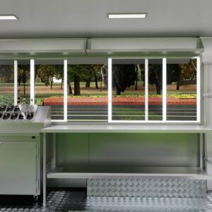 Interior of a mobile food trailer with stainless steel counters for ice cream prep, built by Luxe Custom Co.