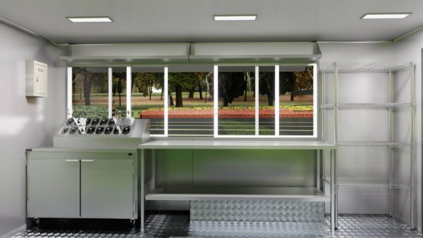 Interior of a mobile food trailer with stainless steel counters for ice cream prep, built by Luxe Custom Co.