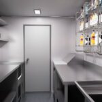 Stainless steel interior of a 13ft custom bar food truck trailer with freezer and hand sink, crafted by Luxe Custom Co food trailer builders.